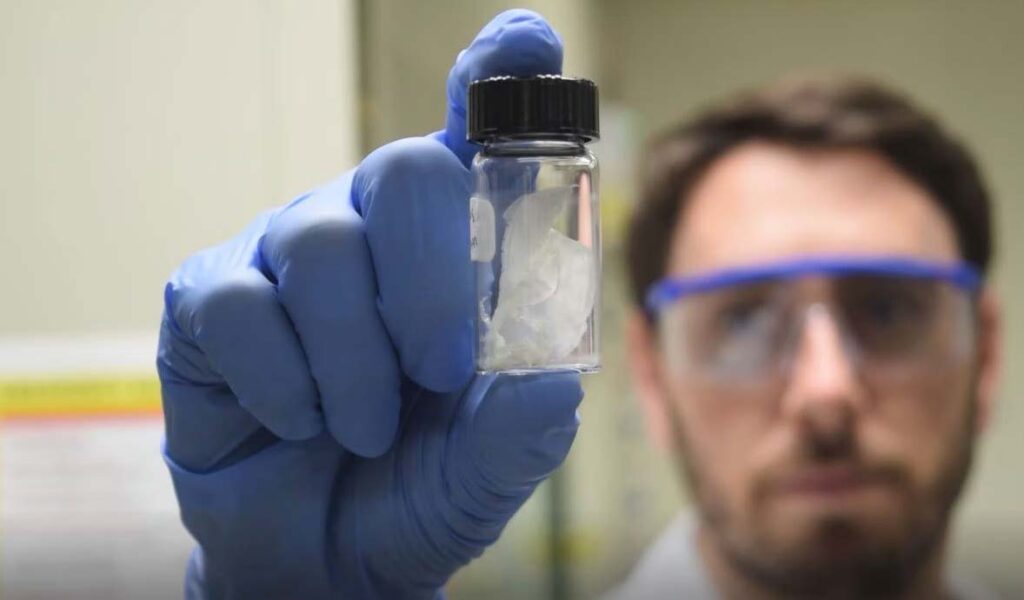 Scientist holding a container