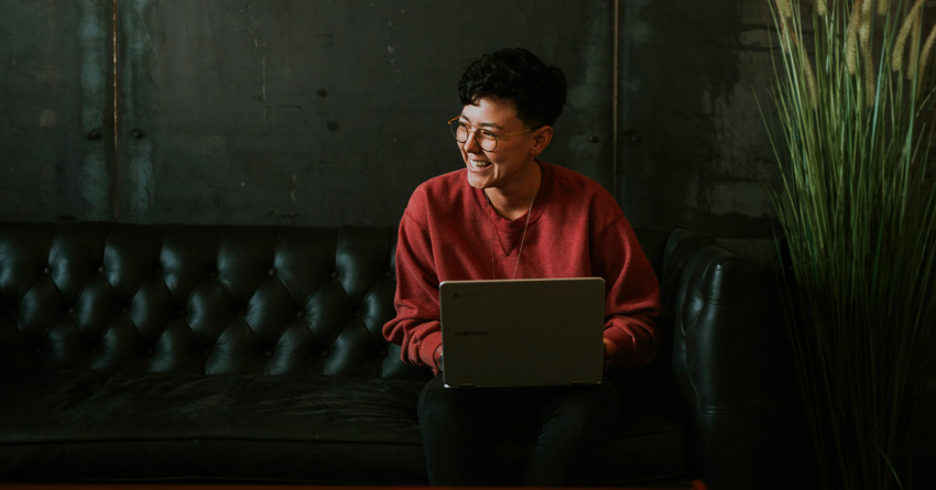Person smiling on a laptop