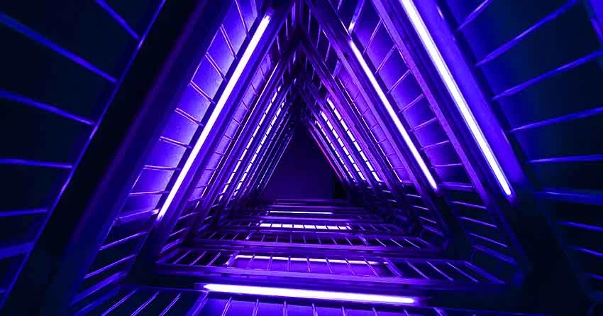 Looking up a stairwell in neon blue